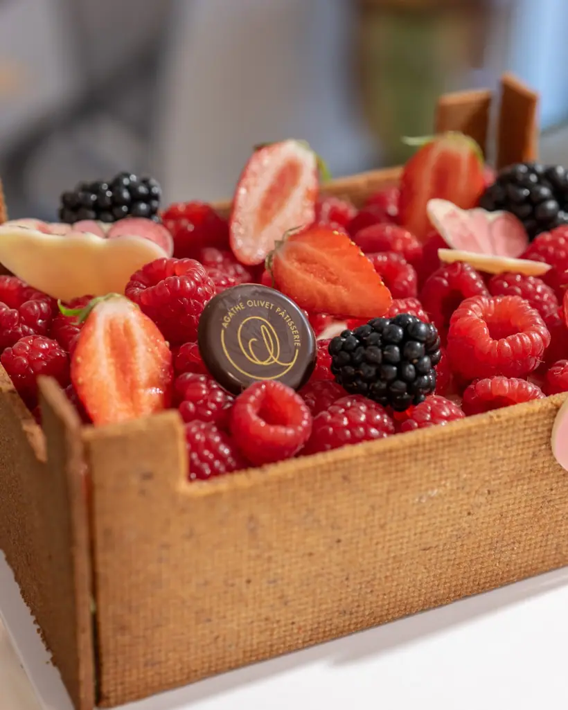 A sweet-pastry crate filled with raspberries, strawberries and blackberries